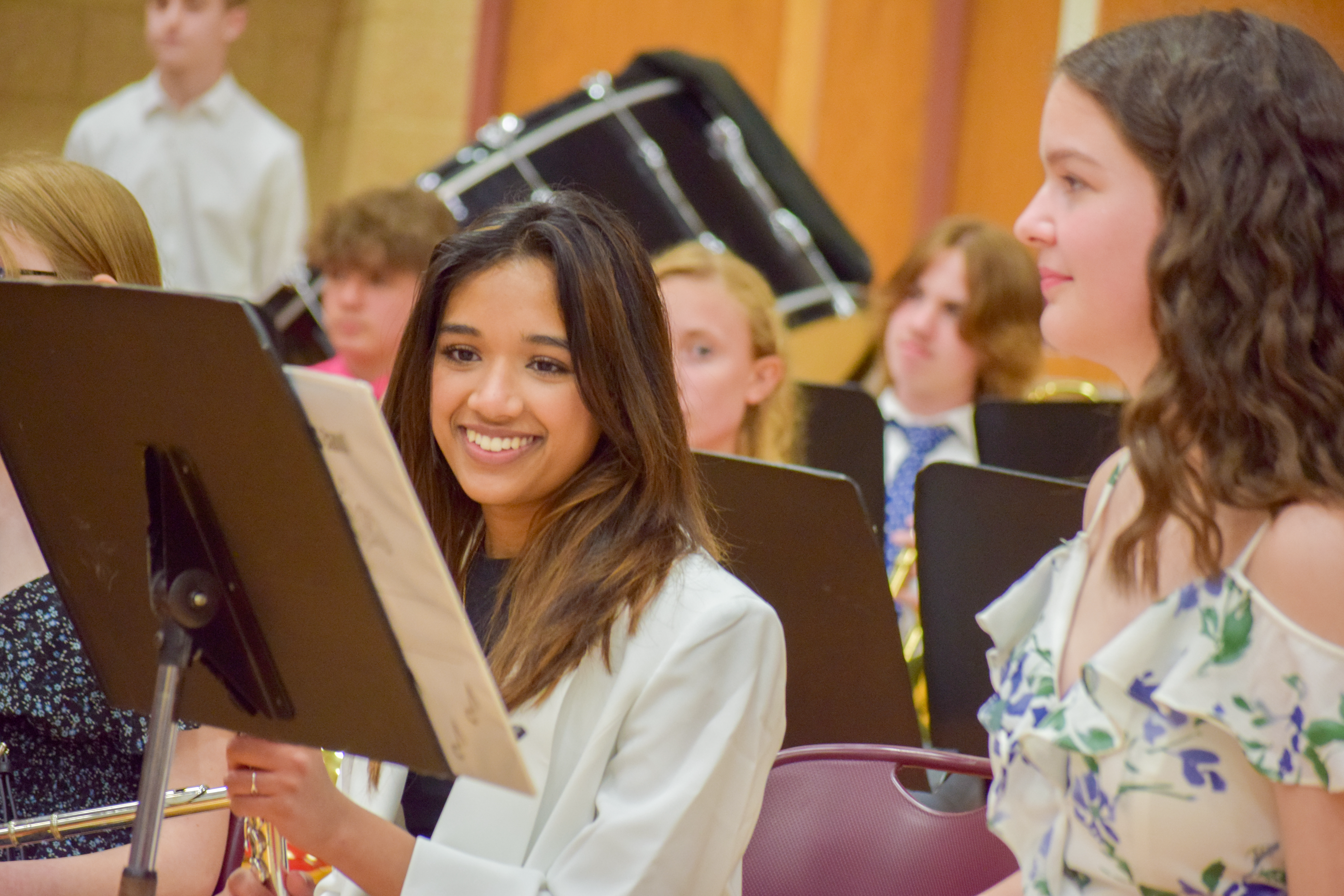 student smiling in band orchestra during 8th grade promotion